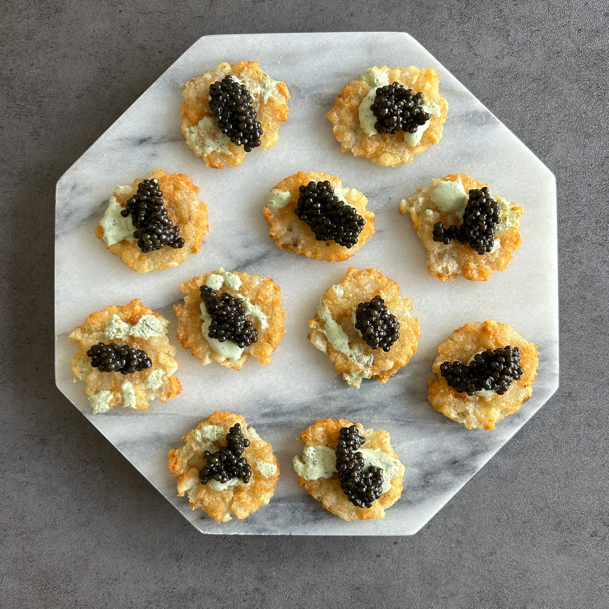 SMASHED TATER TOTS WITH DILL CREAM SAUCE AND CAVIAR– Plaza De Caviar